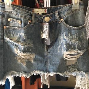 Signature Eight distressed mini jean skirt..